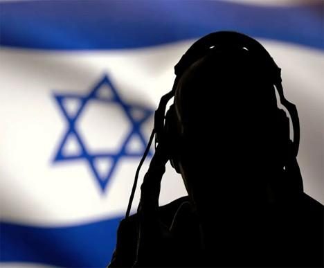 Silhouette of a person wearing headphones in front of the Israeli flag